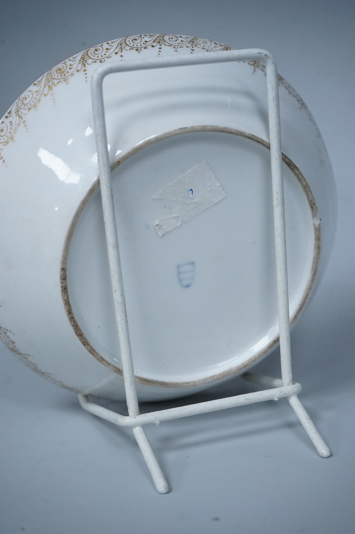 A 19th century Vienna saucer, hand painted with two figures beneath a tree, 15cm in diameter